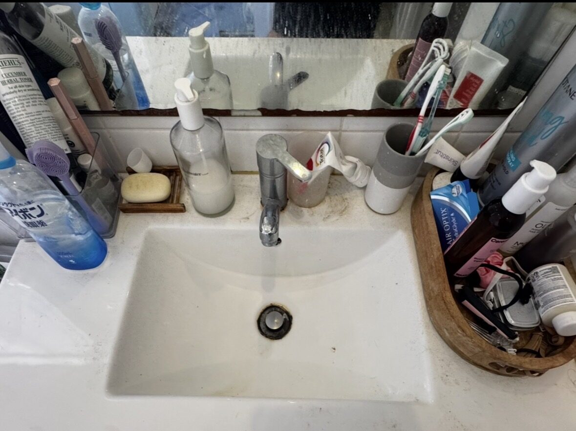 Vanity before deep clean — grime around tap and drain